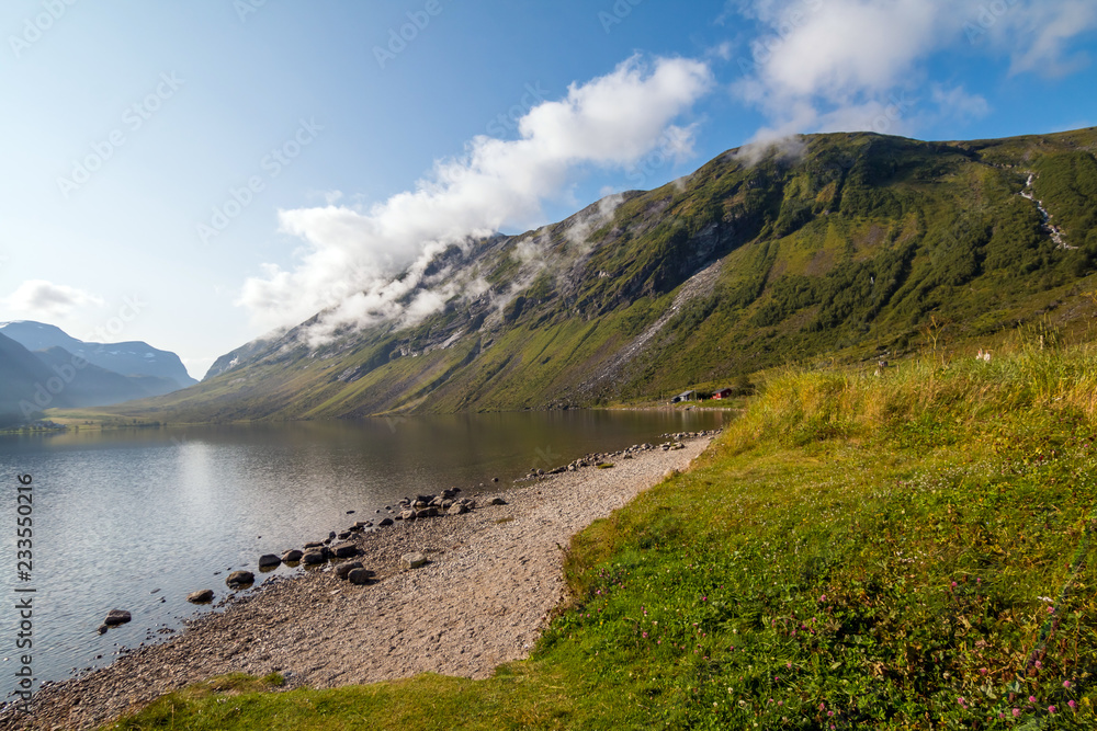 Sunny day in Norway. Green valley in Norway mountains. Beautiful landscapes and mountain lake.