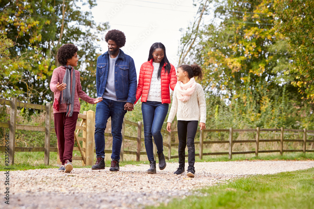 Mixed race family walking together on a country path, low angle