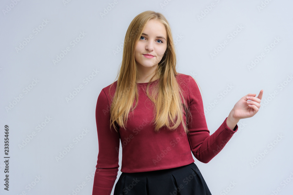 Concept portrait of a beautiful happy blonde girl on a white background smiling and talking with different emotions. Concept portrait of a beautiful happy blonde girl on a white background smiling and talking with different emotions.