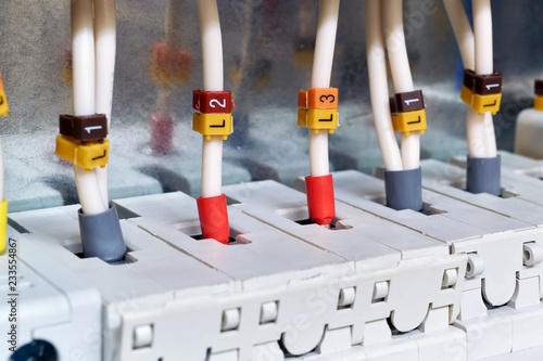 The electrical wires are connected to circuit breakers or fuse holders. The cables have insulated terminals. Reliable and safe connection of electrical equipment. Modern technology and protection.