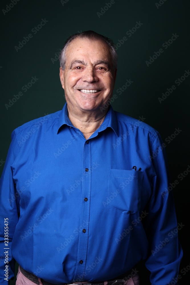 Beautiful older man in front of a colored background Beautiful older man in front of a colored background