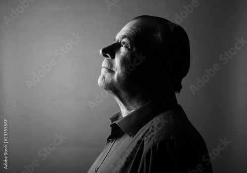 Beautiful older man in front of a colored background