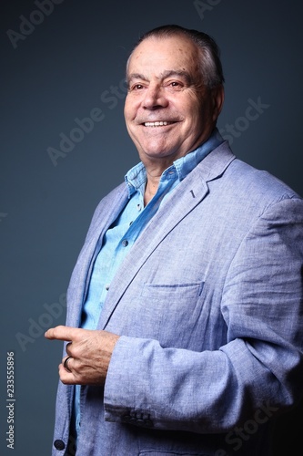 Beautiful older man in front of a colored background