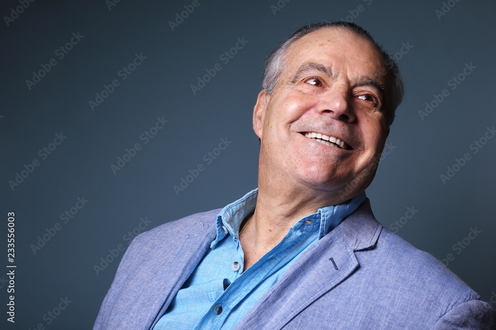 Beautiful older man in front of a colored background Beautiful older man in front of a colored background