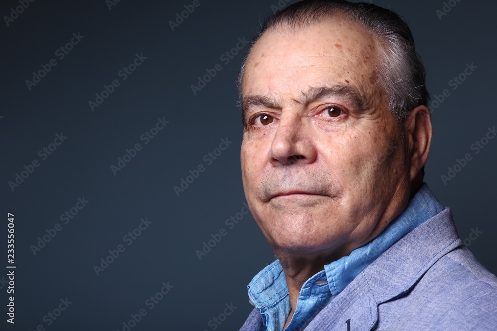 Beautiful older man in front of a colored background Beautiful older man in front of a colored background