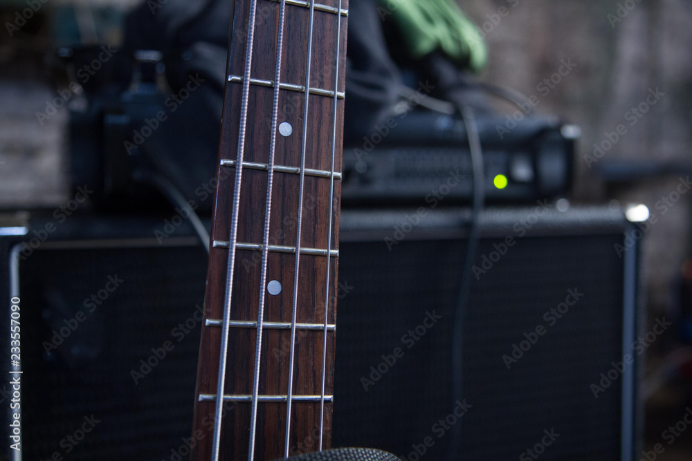 Fretboard of a bass guitar, on amp background. Fretboard of a bass guitar, on amp background.
