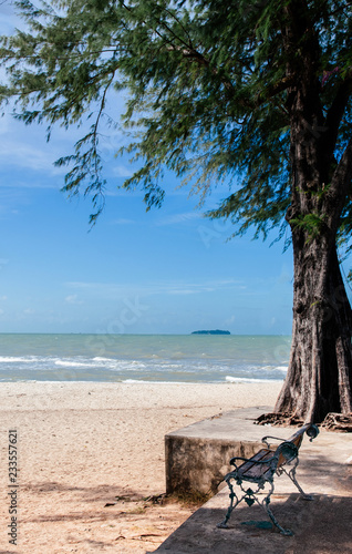 Songkhla, Thailand - Empty bench at Samila Beach in summer photo