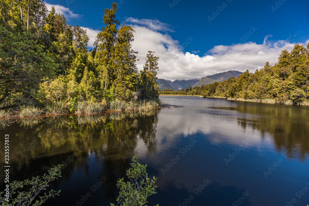 Reflection of mountains in the lake Matheson, New Zealand, Fox Glacier