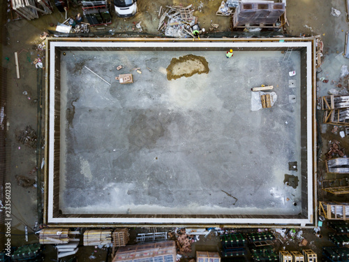 Aerial top view of construction worker work on swimmingpool at construction site