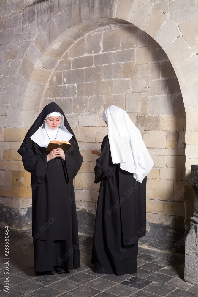 Two nuns in an old convent - obrazy, fototapety, plakaty 
