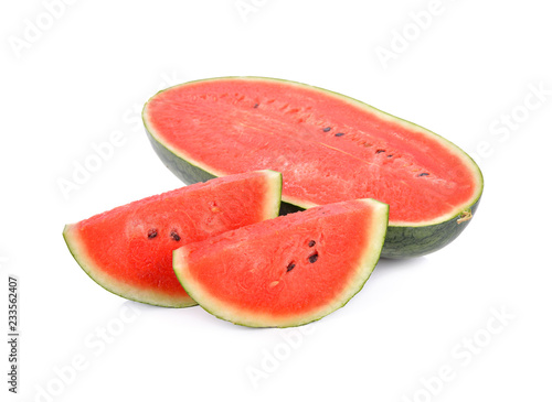 half and portion cut watermelon with seeds on white background