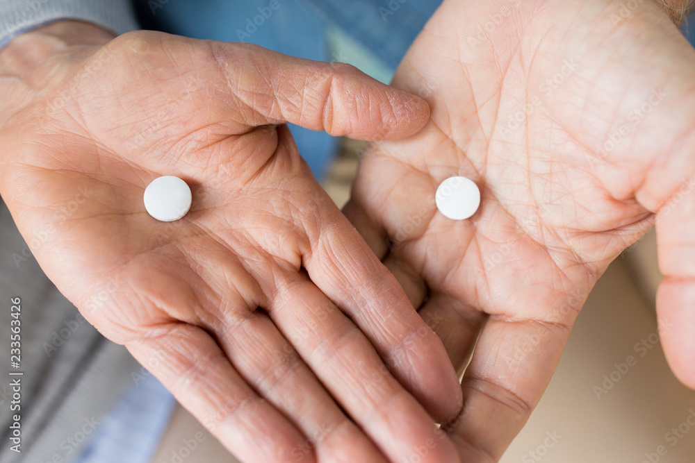 medicine, healthcare and people concept - close up of senior couple hands with pills medicine, healthcare and people concept - close up of senior couple hands with pills
