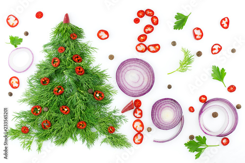 Christmas tree of dill, decorated with chili peppers, close-up with vegetables on a white background. Healthy food and nutrition. Decisions of the new year about a healthy lifestyle.