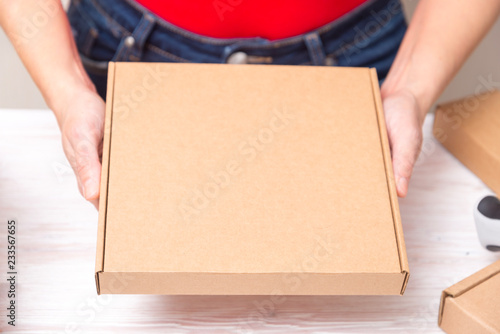 Woman packing cardboard boxes , picking and puttind products © mdbildes