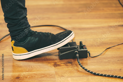 Man using guitar effects pedal