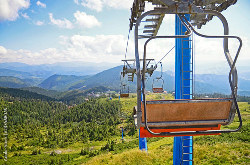  Scenic view of ski lift over field and forest in Carpathian mountains ,Dragobrat, Ukraine. Travel adventure and hiking activity lifestyle in summer 