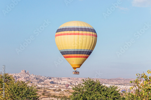 yellow hot air balloon in sky in Cappadocia