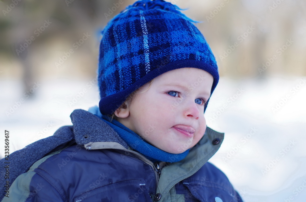 winter portrait of a cute, funny, emotional boy with bright blue eyes and a blush on his cheeks winter portrait of a cute, funny, emotional boy with bright blue eyes and a blush on his cheeks