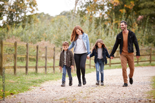 Family On Autumn Walk In Countryside Together