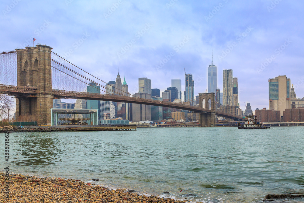 Brooklyn bridge and lower manhattan from peddle  beach in Brooklyn, New York, USA