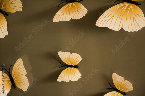 composition of several artificial butterflies on a metal surface