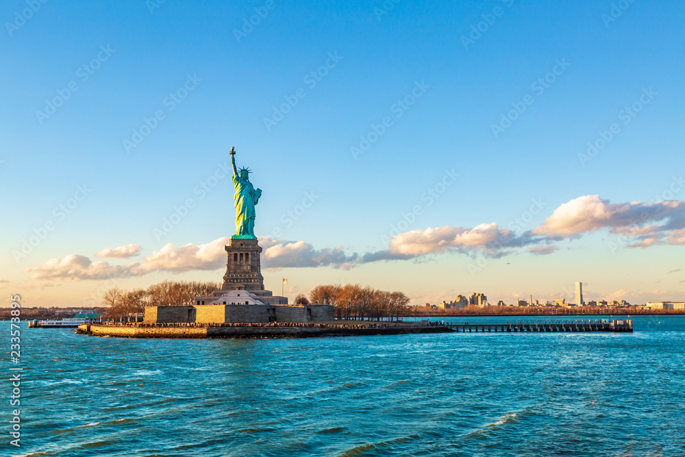 Statue of liberty horizontal during sunset in New York City, NY, USA