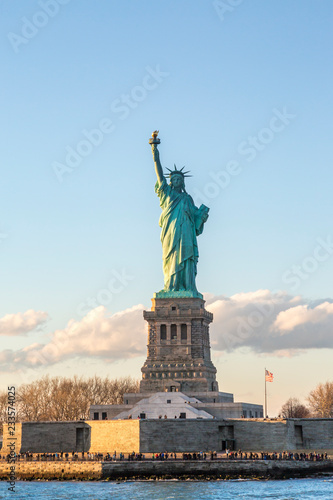 Statue of liberty vertical during sunset in New York City, NY, USA