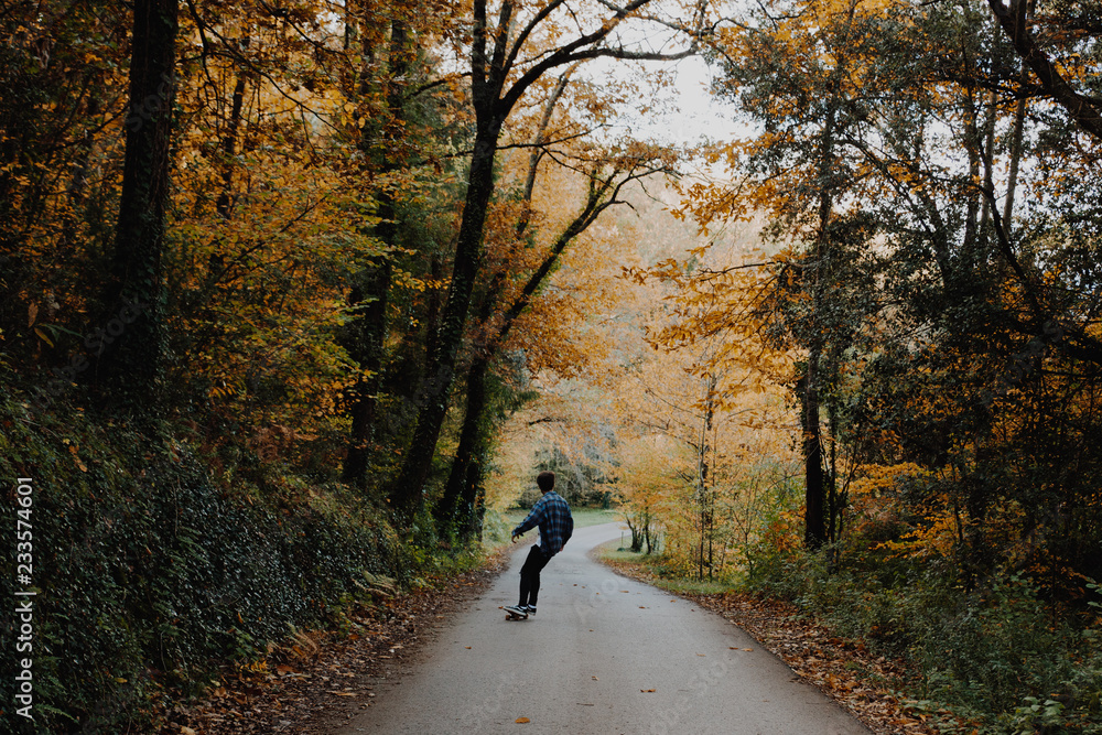 Man Skating in the Autumn Forest in Germany Man Skating in the Autumn Forest in Germany