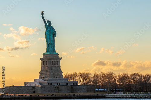Statue of liberty horizontal during sunset in New York City, NY, USA photo