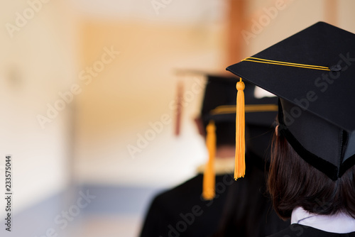 Black graduates wear black suits on graduation day at university.