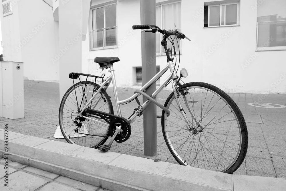 BENIDORM, SPAIN - NOVEMBER 30, 2018.BIKE ATTACHED TO POST ON THE STREET    