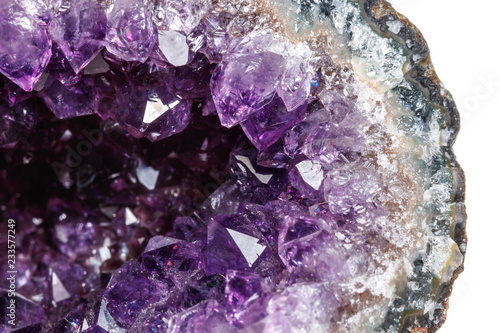 Macro Mineral Stone Amethysts in the rock on a white background photo
