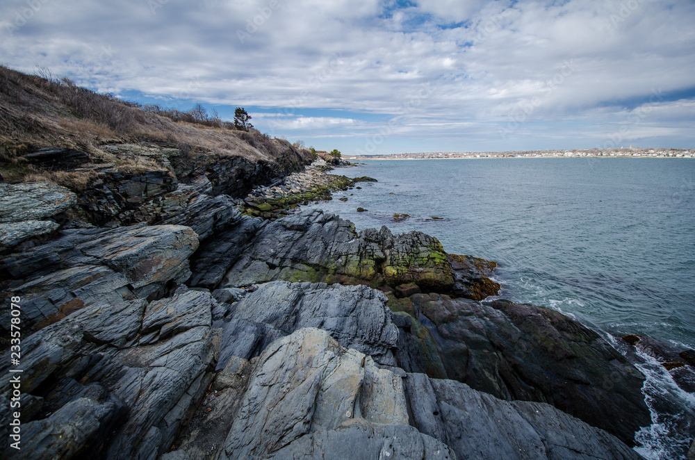 Rhode Island Cliff Walk shows breaking waves along the rocky shoreline of the Atlantic Ocean