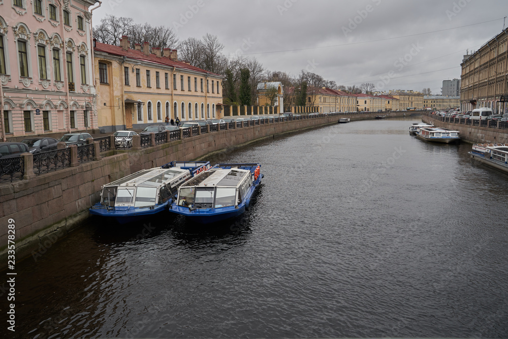 View of one of the canals in St. Petersburg on a cloudy day. The ancient part of the European city and the channel in cloudy weather.
