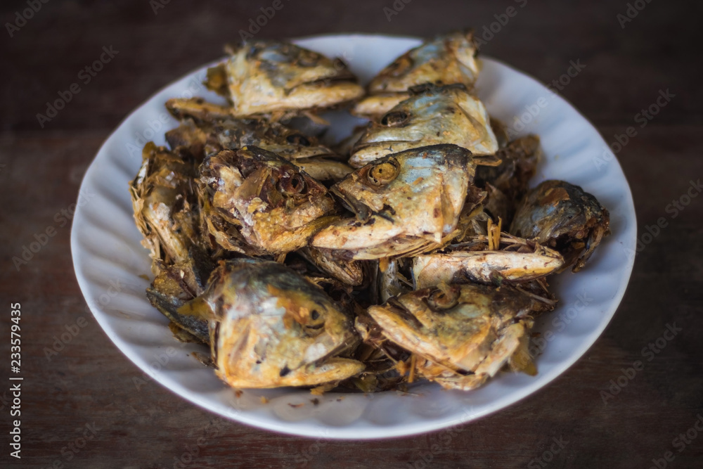 Fried fish heads for a simple meal of rural people in Thailand Fried fish heads for a simple meal of rural people in Thailand
