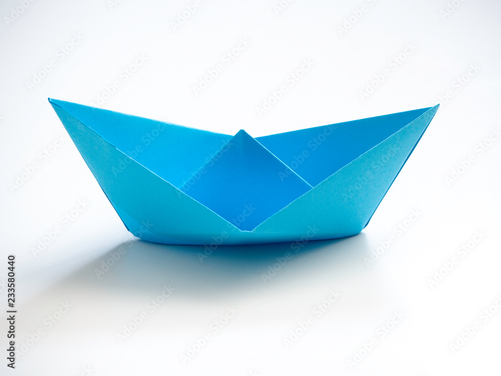 Single Blue paper boat on white Single Blue paper boat on white
