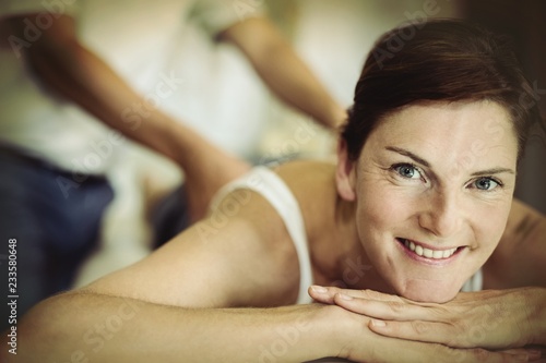 Woman receiving back massage from physiotherapist