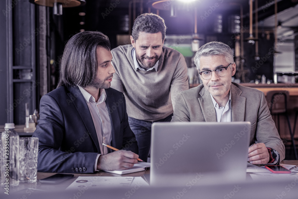 Fototapeta premium Pleased businessman looking at computer during conference