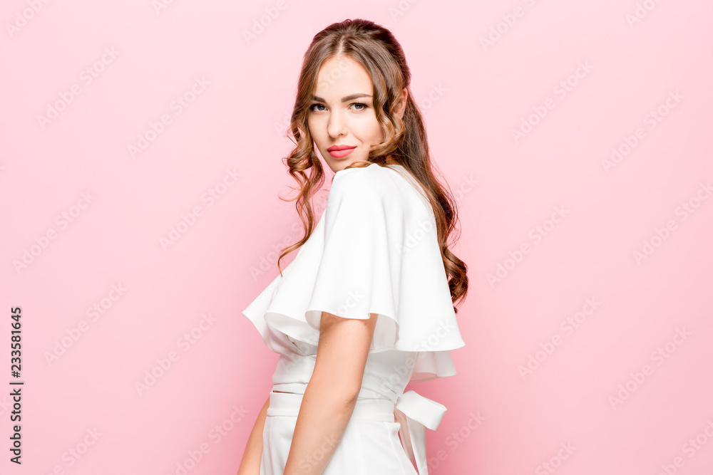 Happy business woman standing and smiling isolated on pink studio background. Beautiful female half-length portrait. Young emotional woman. The human emotions, facial expression concept Happy business woman standing and smiling isolated on pink studio background. Beautiful female half-length portrait. Young emotional woman. The human emotions, facial expression concept