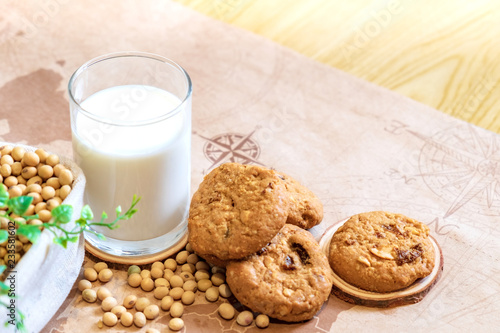 Soy milk in glass and cookie with soy bean on bucket at morning time. Nature healthy concept.