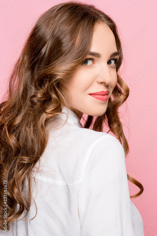 Happy business woman standing and smiling isolated on pink studio background. Beautiful female half-length portrait. Young emotional woman. The human emotions, facial expression concept Happy business woman standing and smiling isolated on pink studio background. Beautiful female half-length portrait. Young emotional woman. The human emotions, facial expression concept