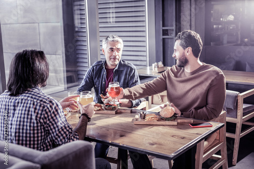 Relaxed coworkers visiting cafe after working day