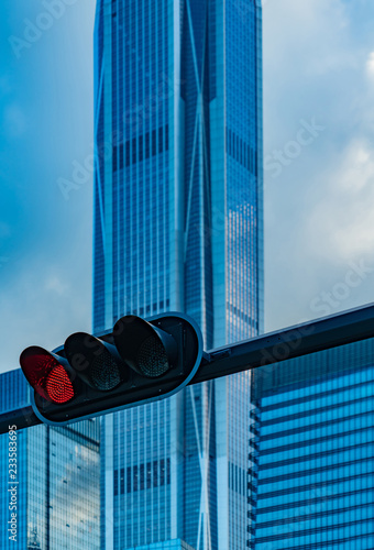 Shenzhen - financial district w red traffic light in front of finance buildings photo