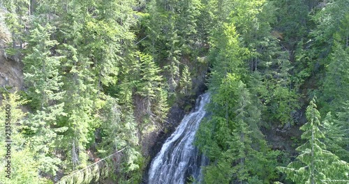 Majestic waterfall in Nakusp, Vancouver, Canada. Drone flying. Aerial view with mountain background. photo