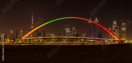 Tolerance Bridge in Dubai at night with impressive Dubai skyline in the background