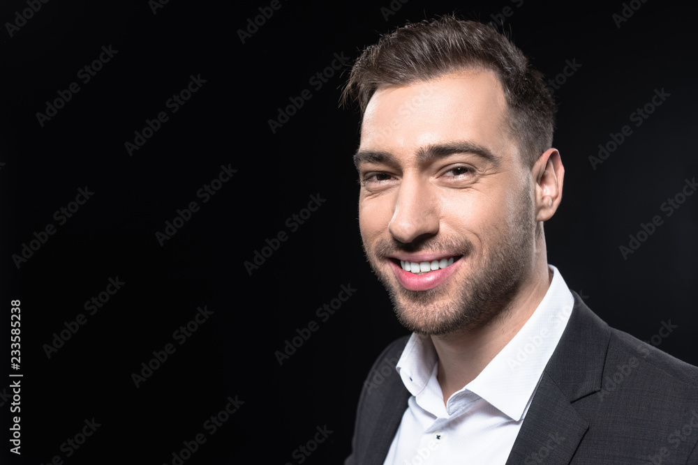 close-up portrait of handsome young businessman looking at camera isolated on black close-up portrait of handsome young businessman looking at camera isolated on black