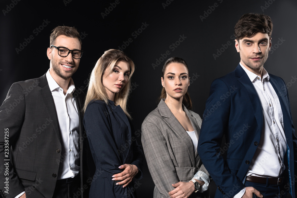 group of business people looking at camera together while standing in row isolated on black group of business people looking at camera together while standing in row isolated on black
