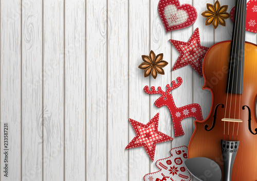 Violin and Christmas ornaments on white wood