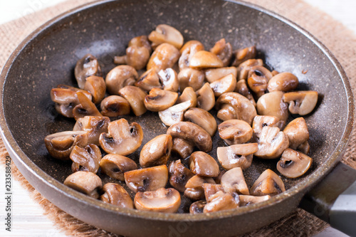 Sliced mushrooms stir-fried in a pan