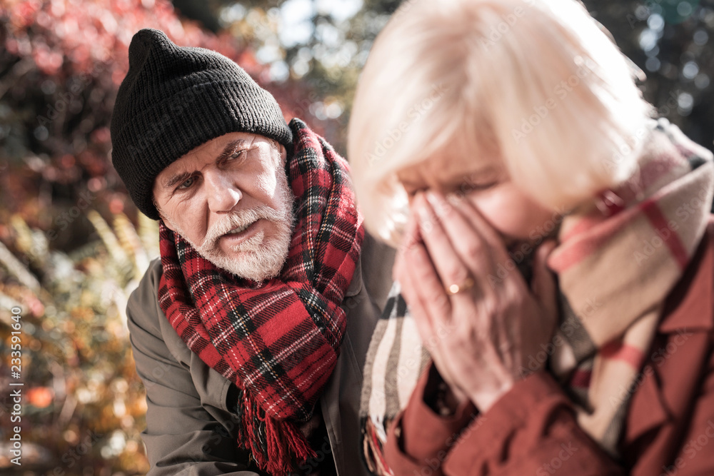 Nice unhappy man trying to calm down his wife Nice unhappy man trying to calm down his wife